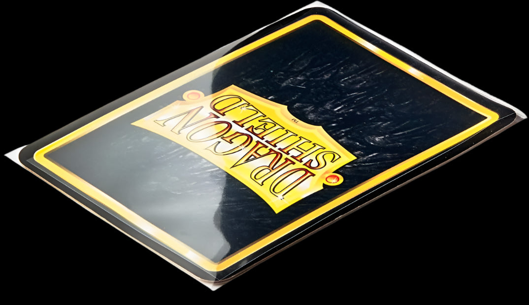 A trading card securely sleeved inside a clear Dragon Shield sealable perfect fit sleeve, showing full edge protection.