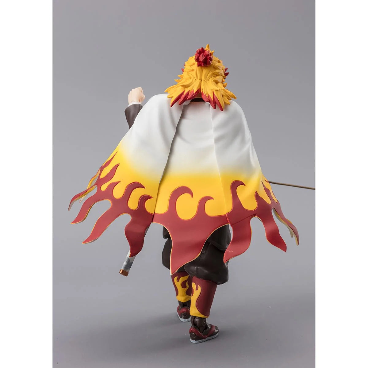 Rear view of Rengoku figure showing detailed flame-patterned cape and sculpted hair.