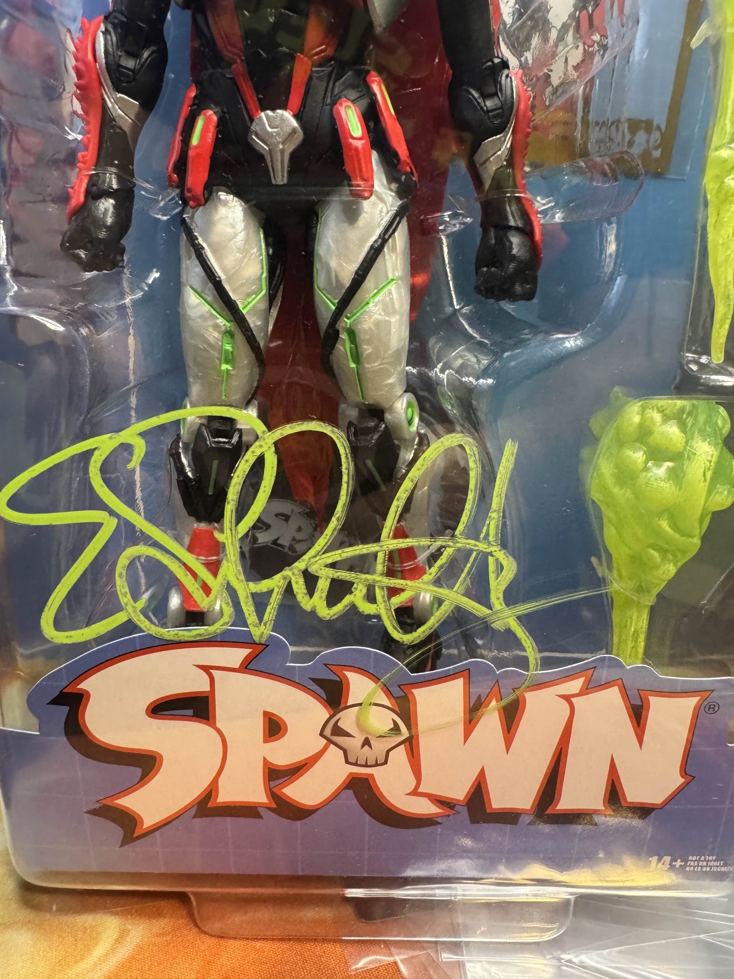 Detailed view of neon green Erica Schultz signature on Spawn The Deviant 30th Anniversary figure packaging